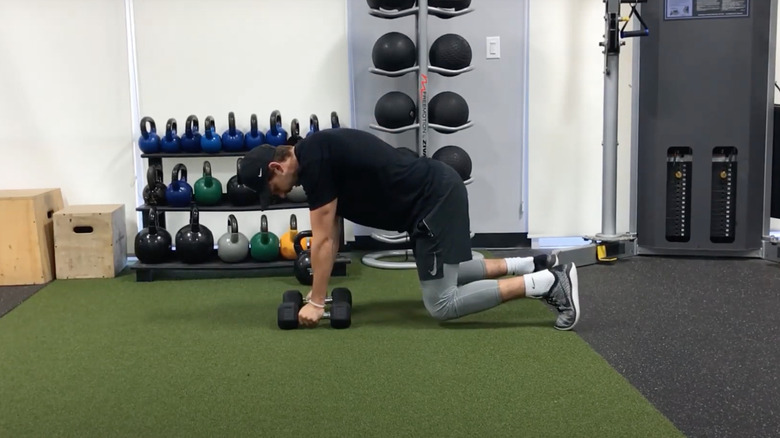 man doing bear plank row