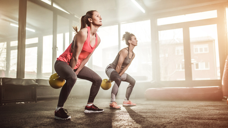 women doing kettlebell swings