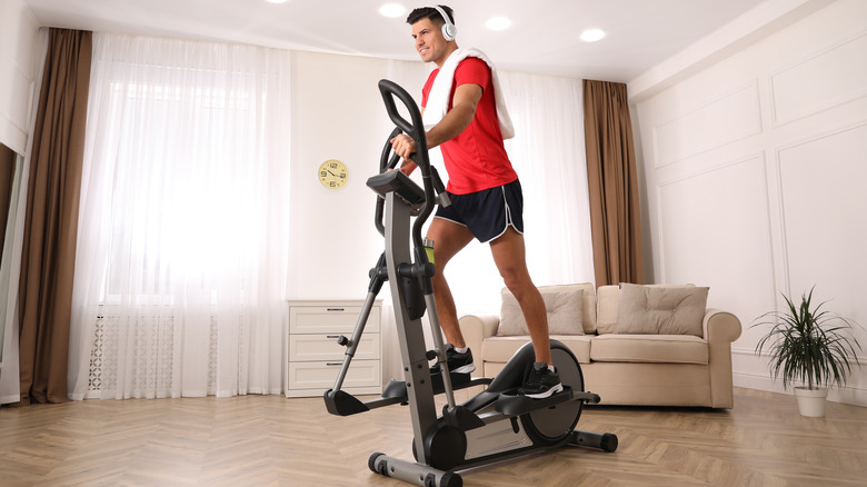 man exercising on an elliptical trainer