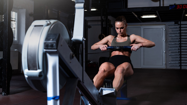 muscular woman on rowing machine