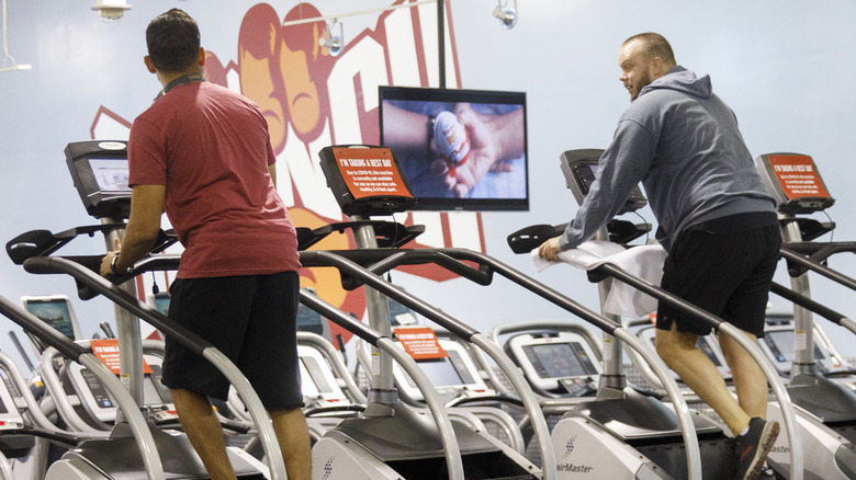 two men exercising on StairMaster