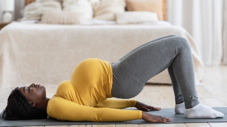 Pregnant woman doing bridge stretch