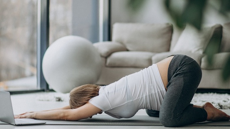 Pregnant woman in child's pose