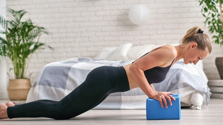 woman doing pushups at home