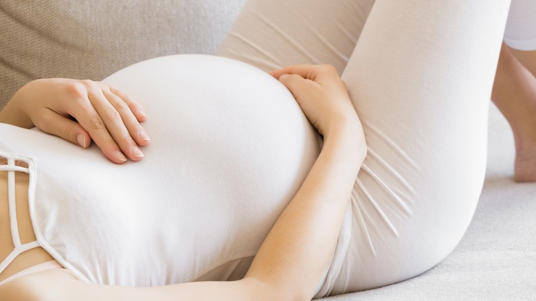 pregnant woman laying on back 