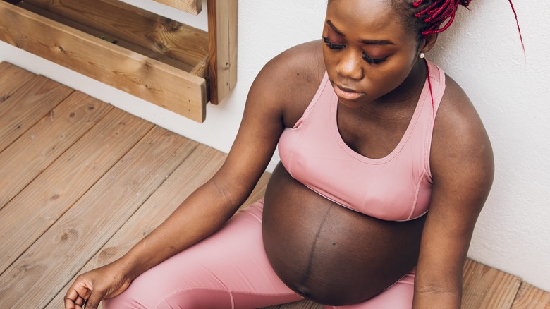 pregnant woman sitting on floor