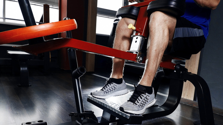 man doing seated calf raises on a machine