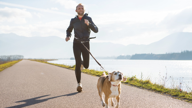 Man running outside with dog