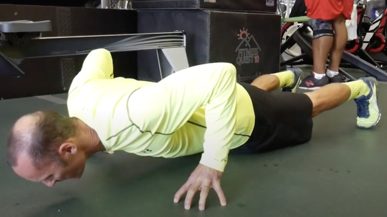 man doing fingertip push-ups