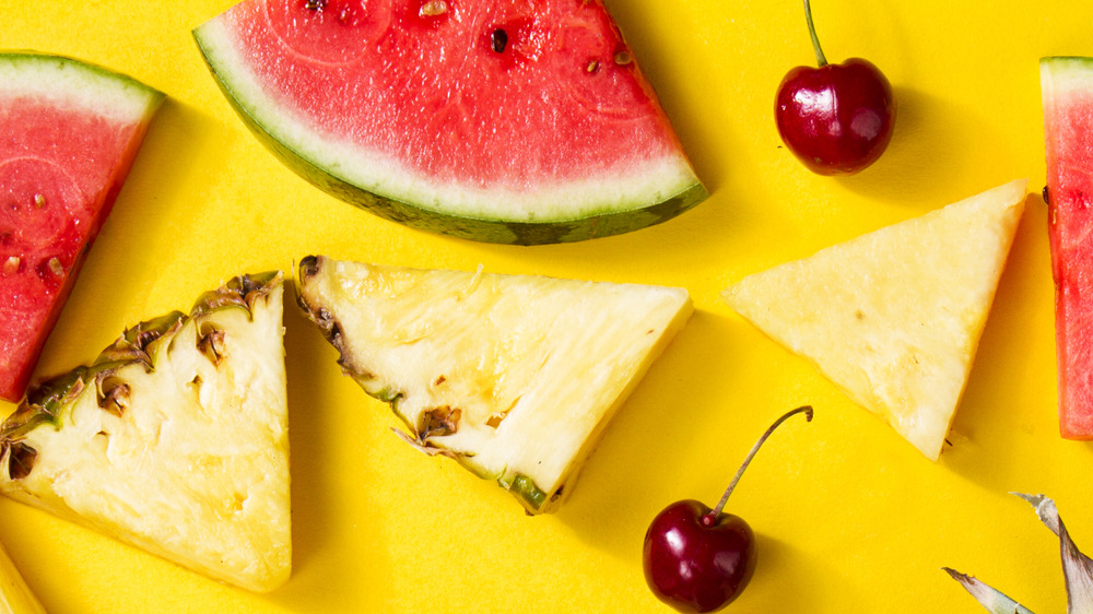 close-up of pineapple slices, watermelon slices, and cherries
