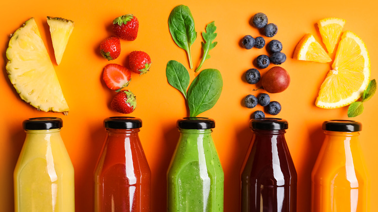 bottles of citrus, berries and vegetable leaves juices