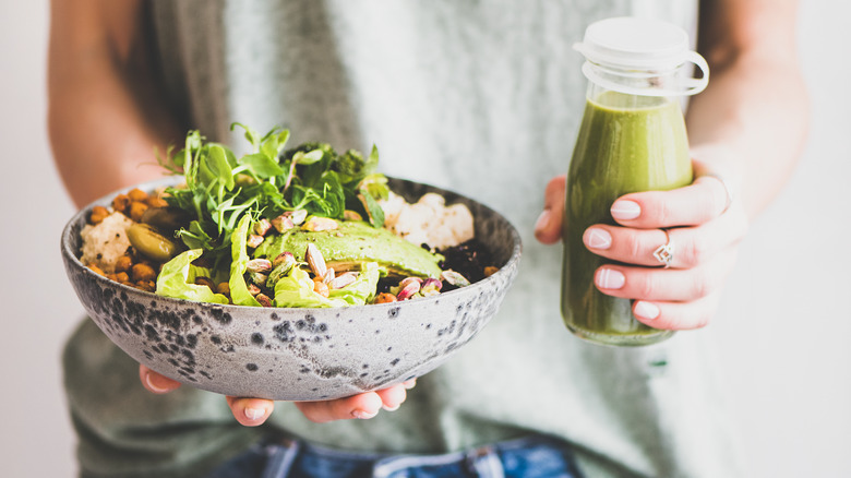 woman holding avocado salad 