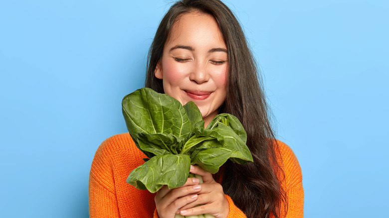 happy woman holding greens