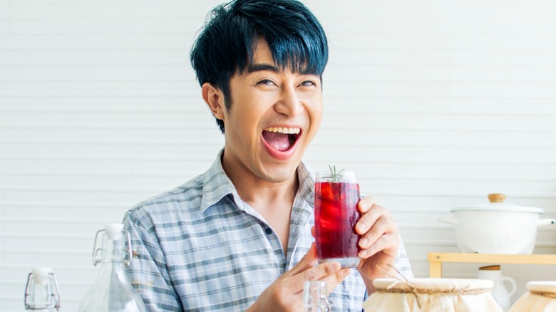 asian man drinking kombucha