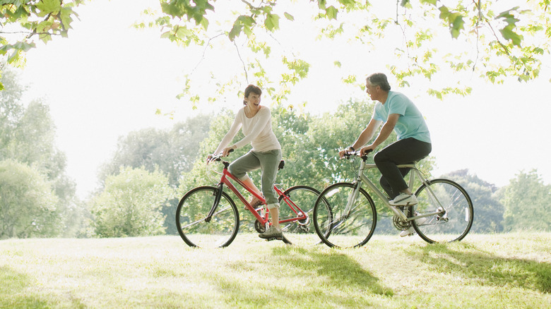 Individuals biking down a trail