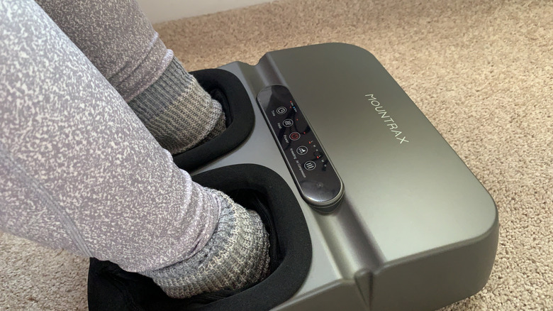 A woman's feet inside a foot massage device