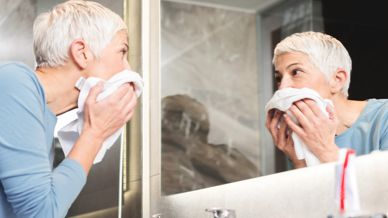 A woman cleaning her face