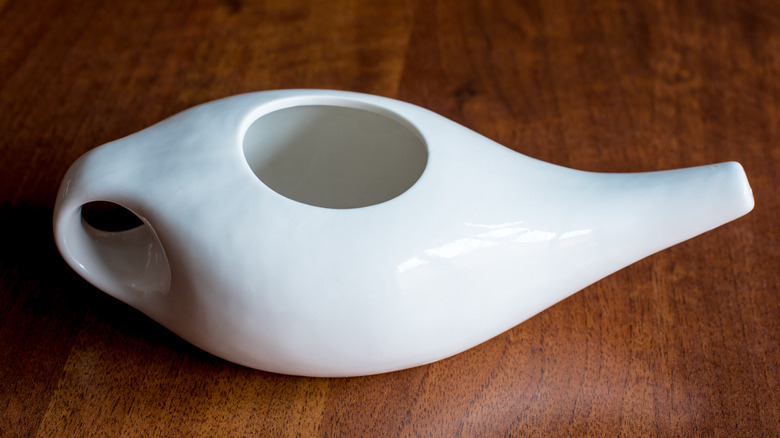 Porcelain neti pot on wood surface