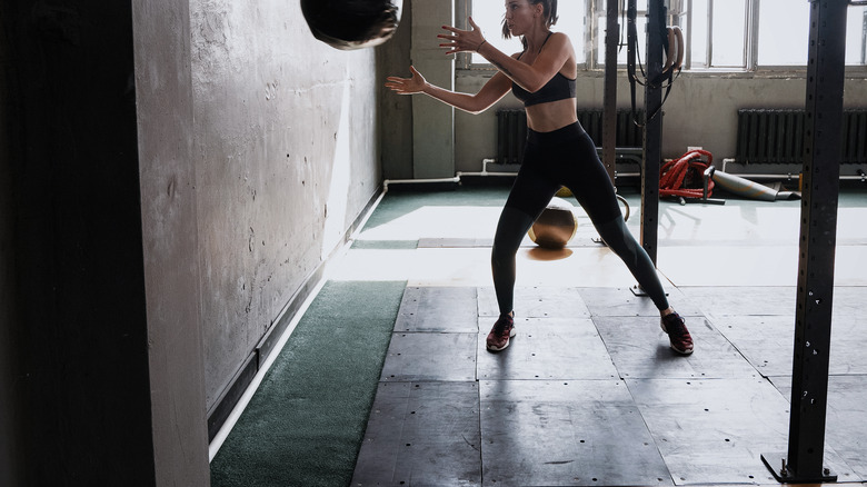 woman throwing medicine ball