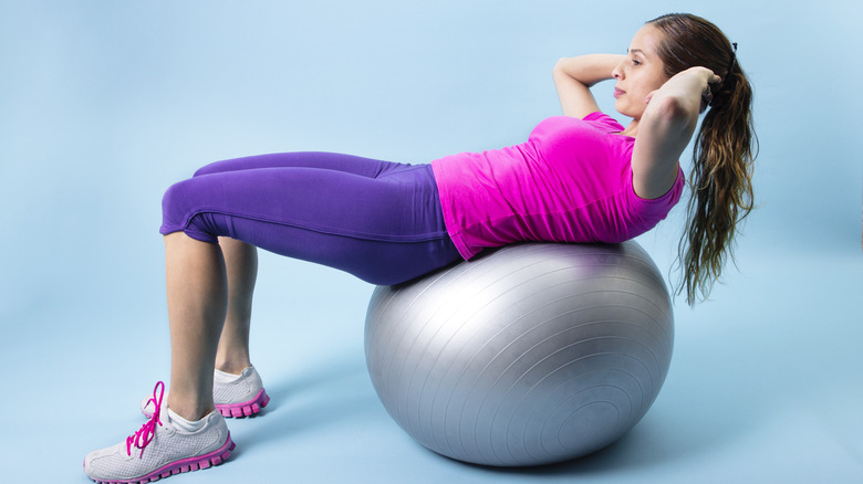 woman balancing on pilates ball