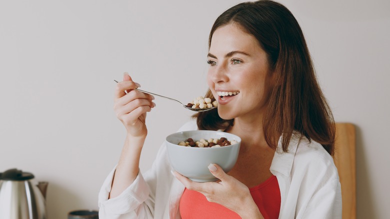 woman eating a bowl of cereal