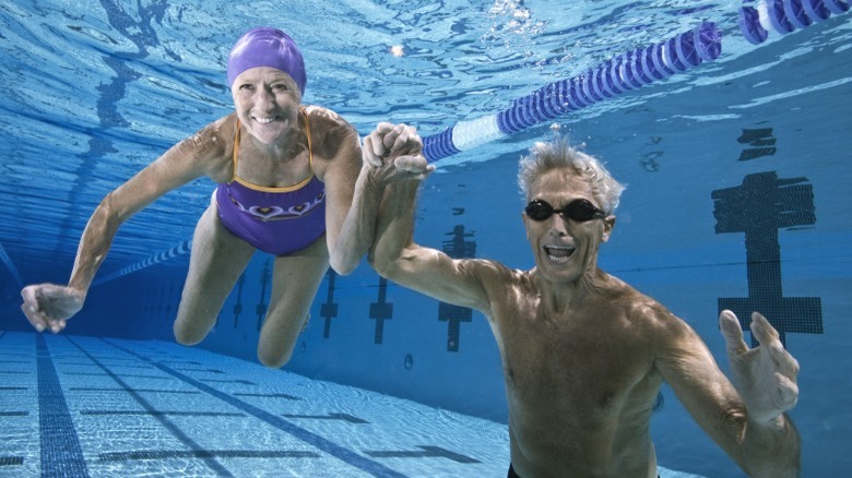 Older couple underwater in pool