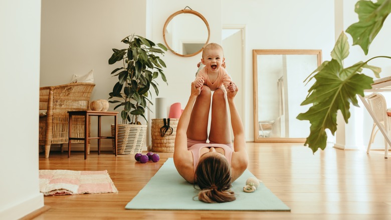 mother doing yoga with her baby