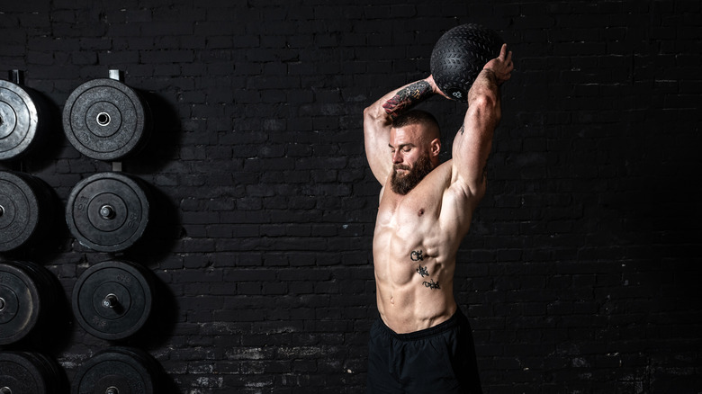 man doing medicine ball slam