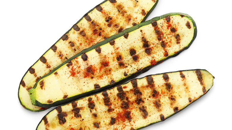 grilled zucchini against a white background