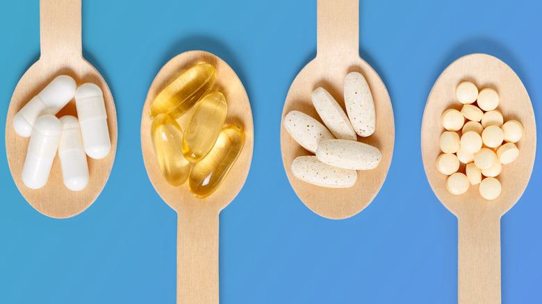 supplements on a wooden spoon