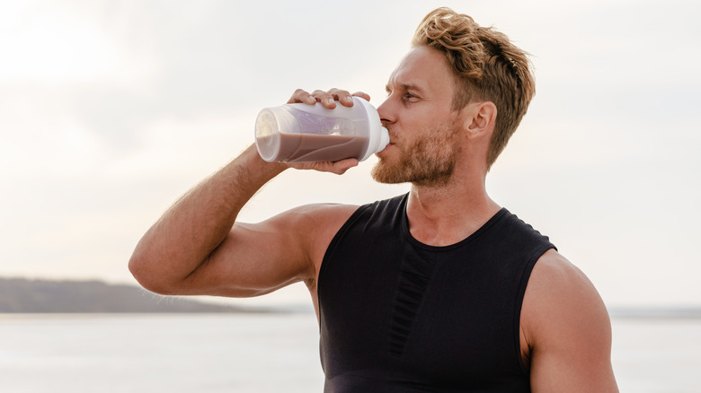 athletic man drinking a protein shake