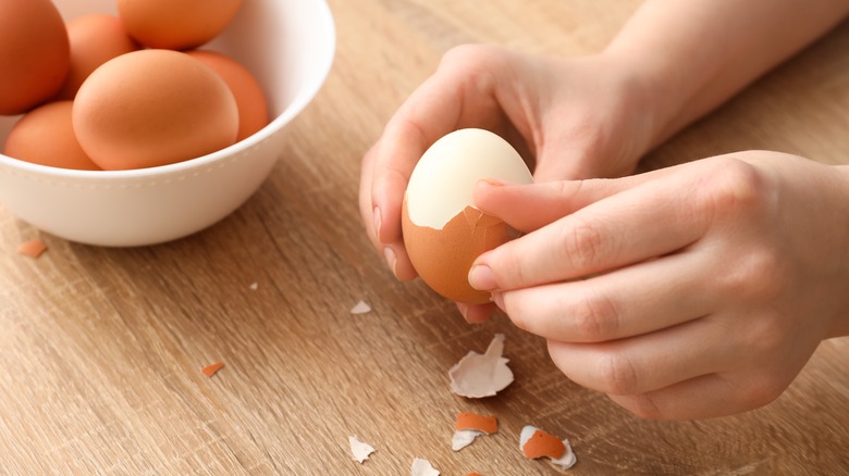 Person peeling egg