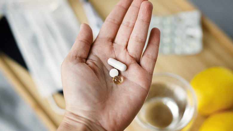 hand holding various supplements