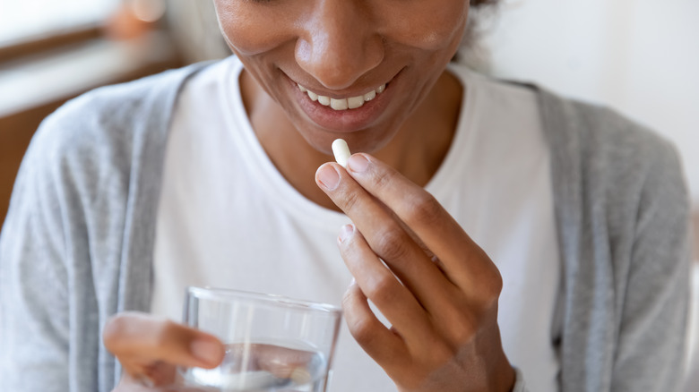 woman taking vitamin