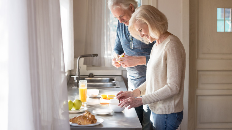 couple making breakfast in kitchen