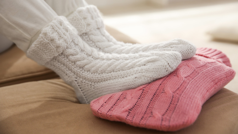 feet in warm socks on heating pad
