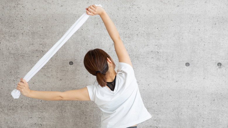 Woman using a towel to stretch