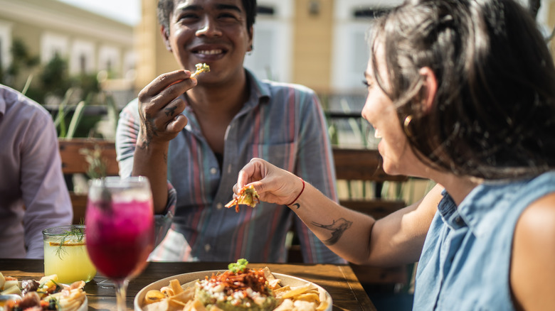 Friends eating guacamole