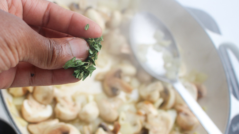 Sprinkling herbs into the dish