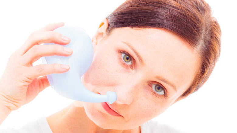 woman using a neti pot