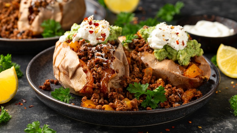 baked sweet potatoes topped with beef, beans, and sour cream