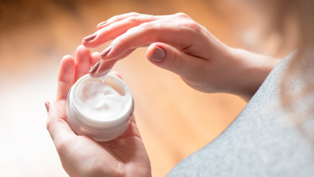 a woman using ointment