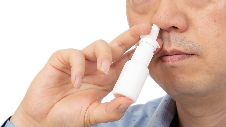 Close up nasal spray use 