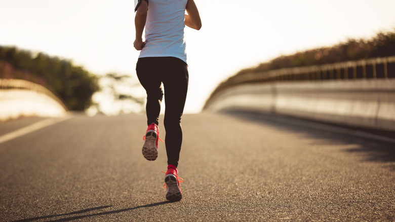 woman wearing nylon fabric leggings while running on the street 