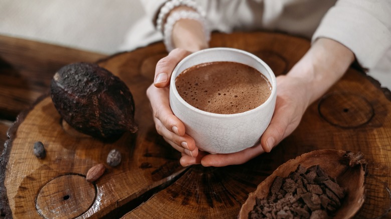 woman holding cup of hot chocolate