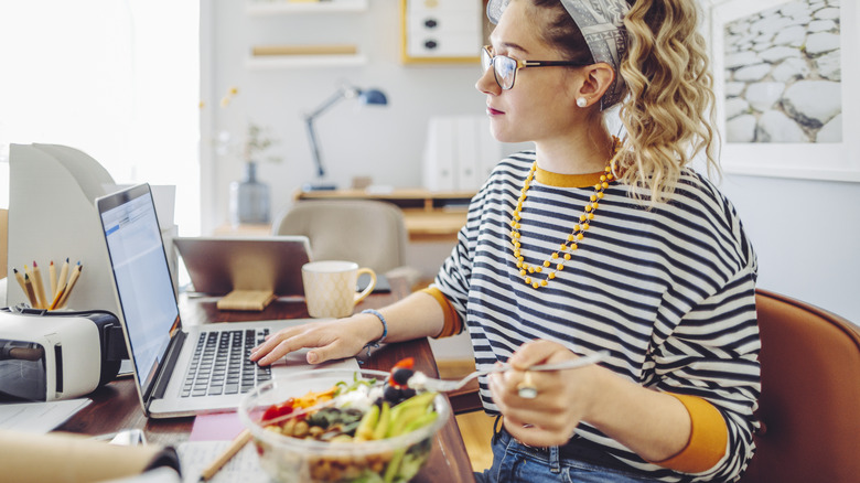 Woman eating salad