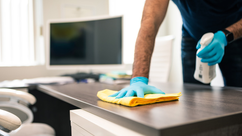 Man cleaning his workspace