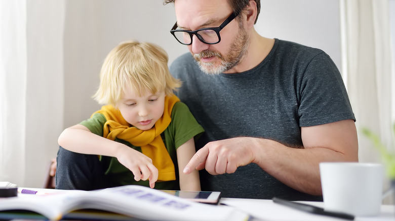 Father helping his kid do homework