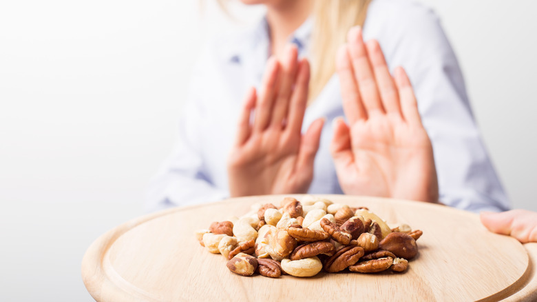 Woman rejecting nuts, a common food allergen