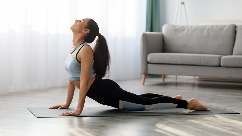 Woman practicing yoga at home